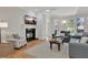 Cozy living room features a fireplace, large windows, and comfortable furnishings at 1112 Kensington Ct, Johns Creek, GA 30022