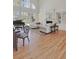 Spacious living room featuring a grand piano, fireplace, and large windows at 1112 Kensington Ct, Johns Creek, GA 30022