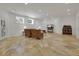 Spacious living room with stone flooring, recessed lighting, and neutral color palette at 1112 Kensington Ct, Johns Creek, GA 30022