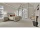 Spacious main bedroom boasts high ceilings, a fireplace, sitting area, and exterior balcony access at 1112 Kensington Ct, Johns Creek, GA 30022