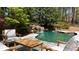 Backyard oasis with a beautiful rock waterfall feature and tranquil seating area at 1112 Kensington Ct, Johns Creek, GA 30022
