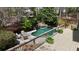 Backyard with a luxurious pool, waterfall feature, and a spacious deck at 1112 Kensington Ct, Johns Creek, GA 30022