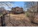 Large backyard of home with a deck and a wood fence surrounded by colorful trees and foliage at 117 Olde Heritage Way, Woodstock, GA 30188