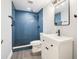 Modern bathroom featuring blue tile shower, white vanity and updated fixtures at 117 Olde Heritage Way, Woodstock, GA 30188