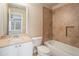 This bathroom features tile walls, shower over tub, vanity and commode at 117 Olde Heritage Way, Woodstock, GA 30188