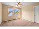 This is a standard bedroom with tan carpet and a view of the street at 117 Olde Heritage Way, Woodstock, GA 30188