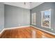 Neutral bedroom with hardwood floors and two bright windows, offering a serene and comfortable living space at 117 Olde Heritage Way, Woodstock, GA 30188