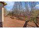 Wooden deck with railings overlooking a natural treed area at 117 Olde Heritage Way, Woodstock, GA 30188