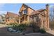 Brick home highlighting mature landscaping, covered porch, and multiple windows, offering curb appeal and natural light at 117 Olde Heritage Way, Woodstock, GA 30188
