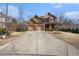Traditional brick home featuring a spacious driveway, well-maintained lawn, and inviting front porch, perfect for suburban living at 117 Olde Heritage Way, Woodstock, GA 30188