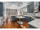 Open kitchen design features gray cabinetry, hardwood floors, stainless appliances, and abundant natural light at 117 Olde Heritage Way, Woodstock, GA 30188