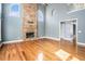 Expansive living room showcasing a stone fireplace, hardwood floors, arched windows, and an open layout for entertaining at 117 Olde Heritage Way, Woodstock, GA 30188