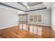 Spacious main bedroom with hardwood floors, trey ceiling, and many windows offering natural light at 117 Olde Heritage Way, Woodstock, GA 30188