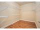 This is a walk-in closet with shelving and hardwood floors at 117 Olde Heritage Way, Woodstock, GA 30188