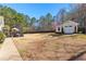 Expansive backyard featuring a shed, lush greenery, and a charming patio area at 340 Housman Dr, Fayetteville, GA 30215