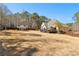 Large backyard with a house, detached shed, and a deck for outdoor living and entertaining at 340 Housman Dr, Fayetteville, GA 30215