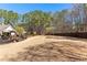 Wide backyard featuring a deck, lush greenery, and a wooden fence for added privacy at 340 Housman Dr, Fayetteville, GA 30215