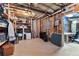 Large unfinished basement space with storage, exposed ceiling and work desk in adjacent room at 340 Housman Dr, Fayetteville, GA 30215