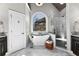 Elegant bathroom with marble floors, soaking tub, shower, and natural light from large window at 340 Housman Dr, Fayetteville, GA 30215