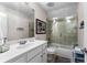 An updated bathroom with tub and glass enclosure, white vanity and modern fixtures at 340 Housman Dr, Fayetteville, GA 30215