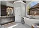 Stunning bathroom with a soaking tub and a large window overlooking the backyard at 340 Housman Dr, Fayetteville, GA 30215