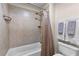 A full bathroom features a shower and tub combination with tile surround and modern fixtures at 340 Housman Dr, Fayetteville, GA 30215