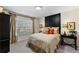 Comfortable bedroom with patterned bedding, decorative pillows, and dark wood accents at 340 Housman Dr, Fayetteville, GA 30215