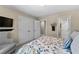 Spacious bedroom view highlighting closet doors, a flat screen TV, chair, and decorative bedspread at 340 Housman Dr, Fayetteville, GA 30215