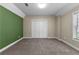 This cozy bedroom offers neutral tones and comfortable carpet at 340 Housman Dr, Fayetteville, GA 30215