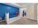 Comfortable carpet and blue accent wall enhance this neutrally decorated bedroom at 340 Housman Dr, Fayetteville, GA 30215
