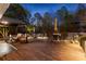 Outdoor deck area with wicker chairs, dining table, and covered pergola, perfect for entertaining at 340 Housman Dr, Fayetteville, GA 30215
