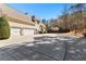 Spacious driveway leading to a three-car garage, plus basketball hoop at 340 Housman Dr, Fayetteville, GA 30215