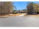 Wide view of home and property featuring mature trees, long driveway and ample space for parking at 340 Housman Dr, Fayetteville, GA 30215
