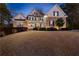 Stunning two-story home featuring a well-manicured lawn and a charming mix of stone and siding at 340 Housman Dr, Fayetteville, GA 30215