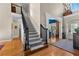 Grand foyer with staircase, hardwood floors, and an arched entryway leading to a bright sitting area at 340 Housman Dr, Fayetteville, GA 30215