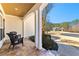 Inviting covered front porch with stone flooring and comfortable seating, perfect for relaxing outdoors at 340 Housman Dr, Fayetteville, GA 30215