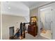Hallway with dark railings leading to staircase and doorway to the bathroom with tile floors at 340 Housman Dr, Fayetteville, GA 30215