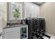Convenient laundry room with modern washer and dryer, sink, and beverage cooler at 340 Housman Dr, Fayetteville, GA 30215