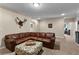 Inviting living room with a large leather sofa and an ottoman at 340 Housman Dr, Fayetteville, GA 30215