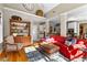 Open concept living area with hardwood floors, a cozy red sofa, and direct access to the kitchen at 340 Housman Dr, Fayetteville, GA 30215