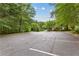 Exterior view of the community parking lot with ample spots available and green space views at 340 Housman Dr, Fayetteville, GA 30215