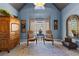 Bright sitting area with blue walls, decorative rug, vintage furniture and natural light at 340 Housman Dr, Fayetteville, GA 30215