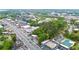 Wide aerial view of the neighborhood with lush trees, a nearby main street, and commercial and residential buildings at 3665 Chestnut Dr # A2, Atlanta, GA 30340