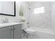 Beautiful bathroom featuring marble-look shower walls, new fixtures, and gray vanity with storage at 3665 Chestnut Dr # A2, Atlanta, GA 30340