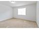 This bedroom features a window that provides plenty of natural light, as well as neutral carpeting at 3665 Chestnut Dr # A2, Atlanta, GA 30340