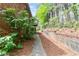Exterior view of brick home with small window and small tree; walkway extending to the backyard at 3665 Chestnut Dr # A2, Atlanta, GA 30340