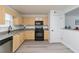 Kitchen highlighting blonde cabinets, stainless steel appliances, gray countertops, and hardwood floors at 3665 Chestnut Dr # A2, Atlanta, GA 30340
