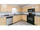 Kitchen featuring blonde cabinets, stainless steel appliances, gray countertops, and hardwood floors at 3665 Chestnut Dr # A2, Atlanta, GA 30340