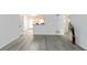 View of an open-concept space leading to a well-lit kitchen with hardwood floors and neutral paint at 3665 Chestnut Dr # A2, Atlanta, GA 30340