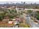 Aerial view of the neighborhood, showcasing mature trees and skyline view of downtown in the background at 591 E Morningside Ne Dr, Atlanta, GA 30324